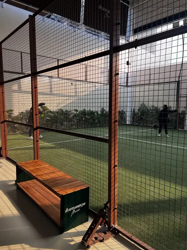 Courtside bench beside the glass